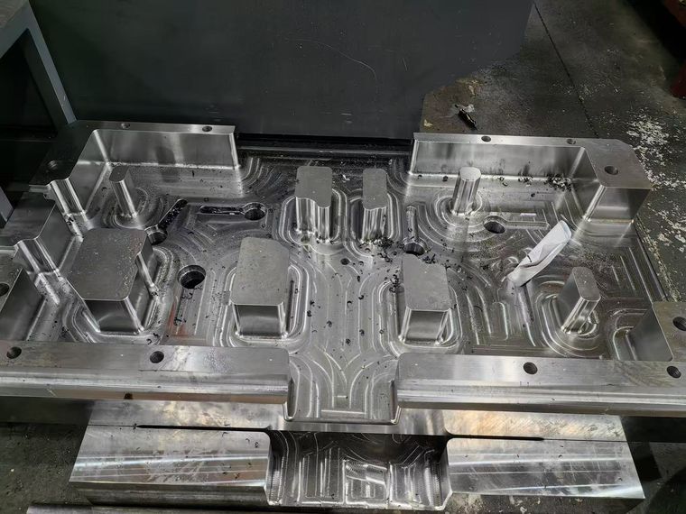 Set of finish-machined mold cores laid out on a workbench
